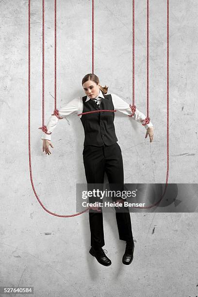 businesswoman bounds with ropes - vastzitten stockfoto's en -beelden