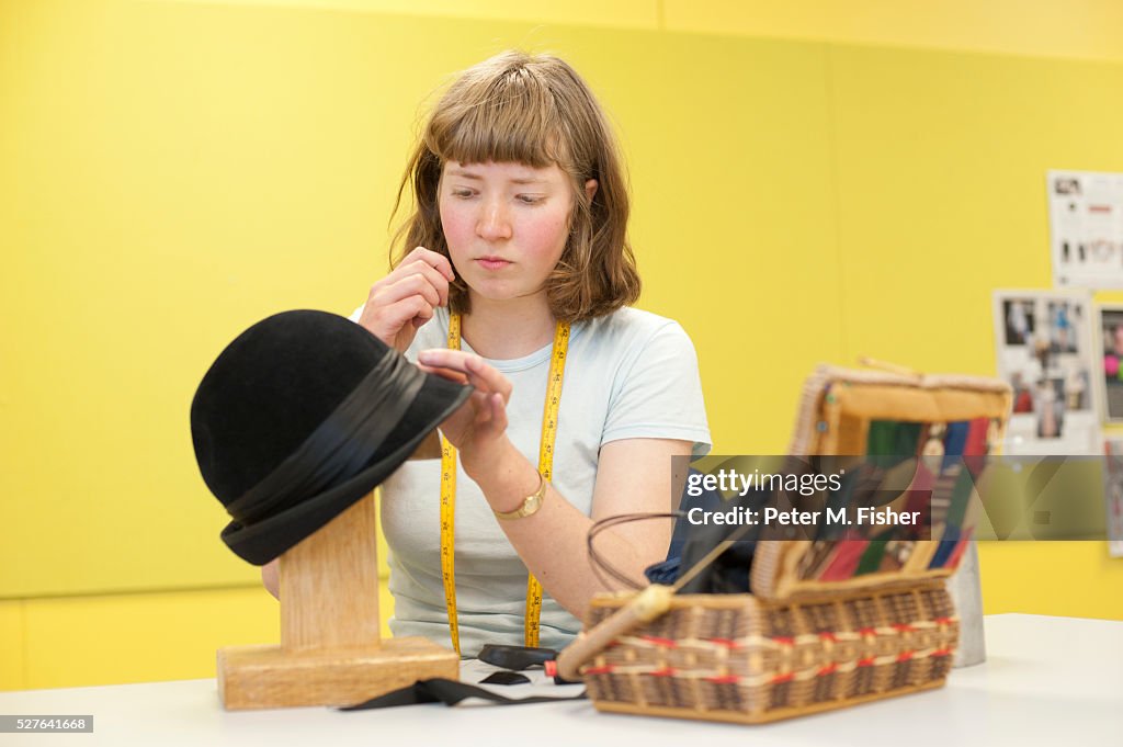 Female student making hat in workshop