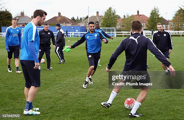 Riyad Mahrez of Leicester City warms up with team mates during a Leicester City training session at Belvoir Drive Training Ground on May 3, 2016 in...