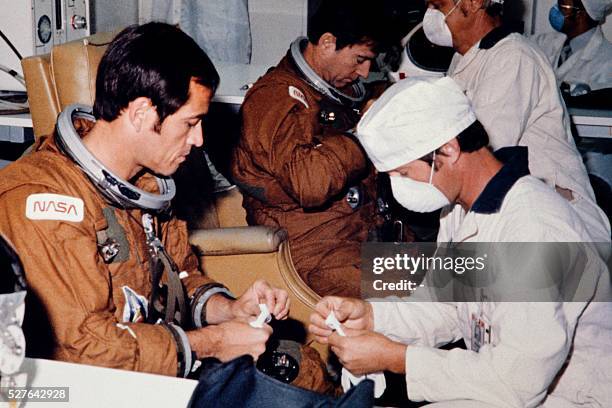 Technicians assist astronauts John Young and Robert Crippen in suit-up operations in Kennedy's Operations and Checkout Building on the morning of...