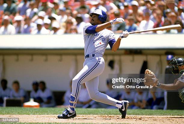 George Bell of the Toronto Blue Jays swings at a pitch during a 1989 game against the Oakland Athletics at the Oakland-Alameda Coliseum in Oakland,...