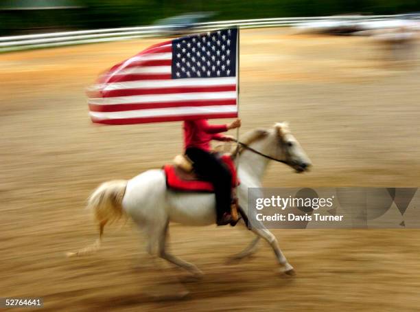Sarah Harper rides "Fandango Mist" as she practices presenting the American flag before services May 5, 2005 at the Carolina Cowboy Church in...