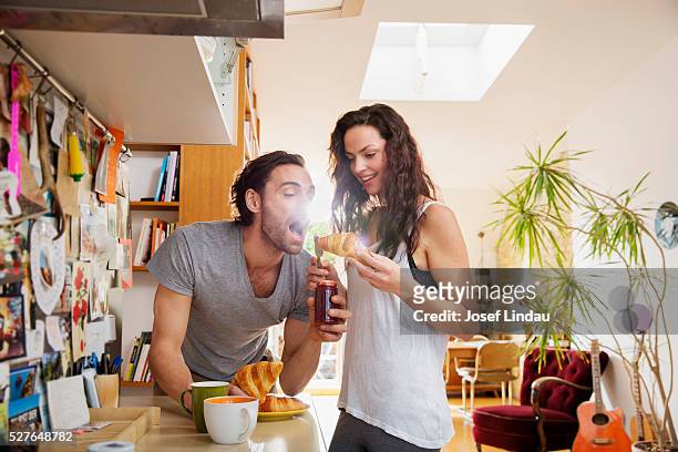 couple having breakfast at home - croissant jam stock pictures, royalty-free photos & images