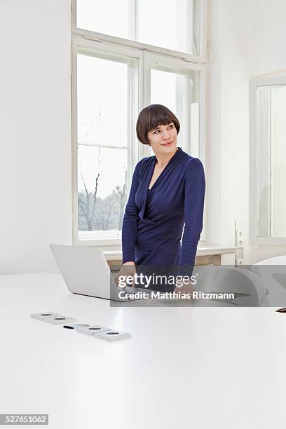 woman using laptop in office - archival office stock pictures, royalty-free photos & images