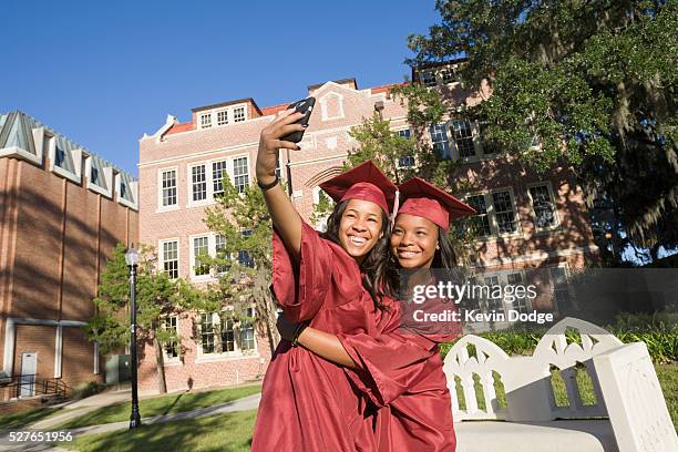 happy college graduates taking photo with smartphone - black woman graduation stock pictures, royalty-free photos & images