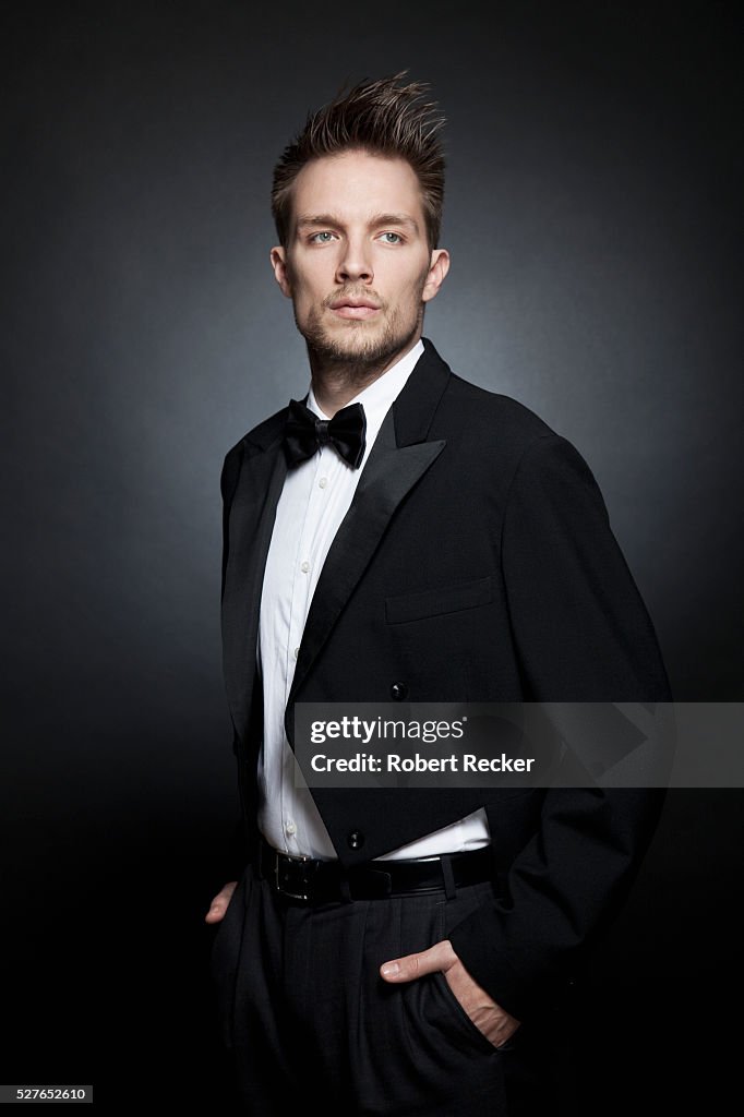 Studio portrait of young wearing tailcoat