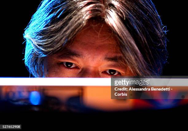 Japanese musician and composer Ryuichi Sakamoto works on his computer while perfoming at Rome Auditorium for the closing concert of Festa...
