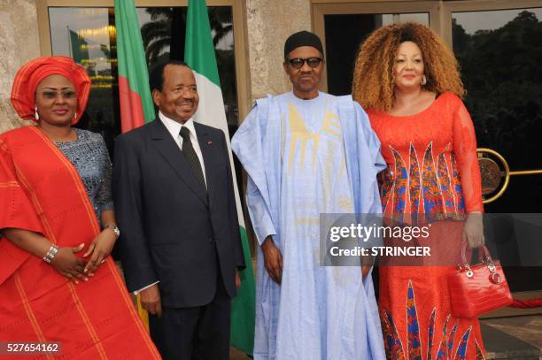 Nigerian President Mohammadu Buhari and his Cameroonian counterpart Paul Biya pose with their wives Chantal Biya and Aisha Buhari at the presidential...