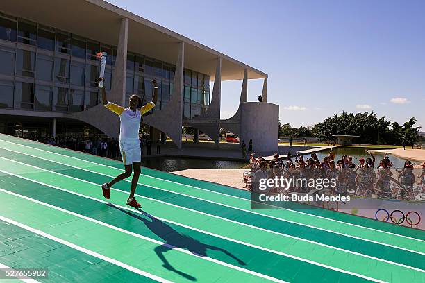 Brazilian volleyball player Fabiana Claudino holds the Olympic torch after receiving it from Brazilian President Dilma Rousseff at Planalto Palace in...