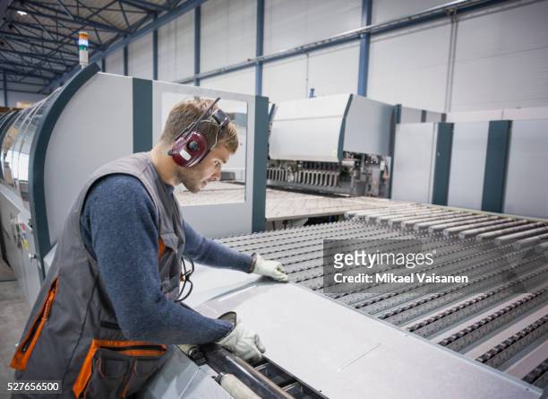 technician at work in sheet metal component factory - blech stock-fotos und bilder