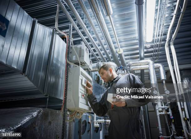 technician with air handling and conditioning unit - air conditioning stock pictures, royalty-free photos & images