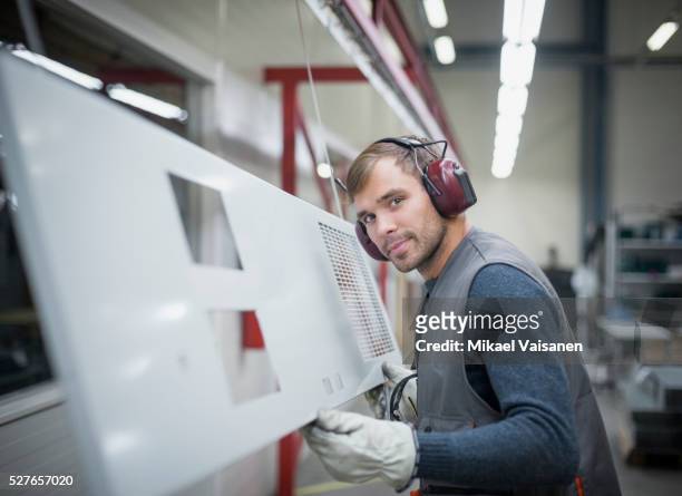 technician at work in sheet metal component factory - industrial laborer foto e immagini stock