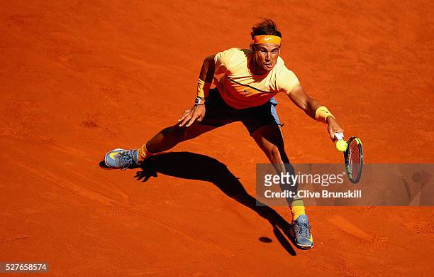 Rafael Nadal of Spain plays a forehand against Andrey Kuznetsov of Russia in their second round match during day four of the Mutua Madrid Open tennis...