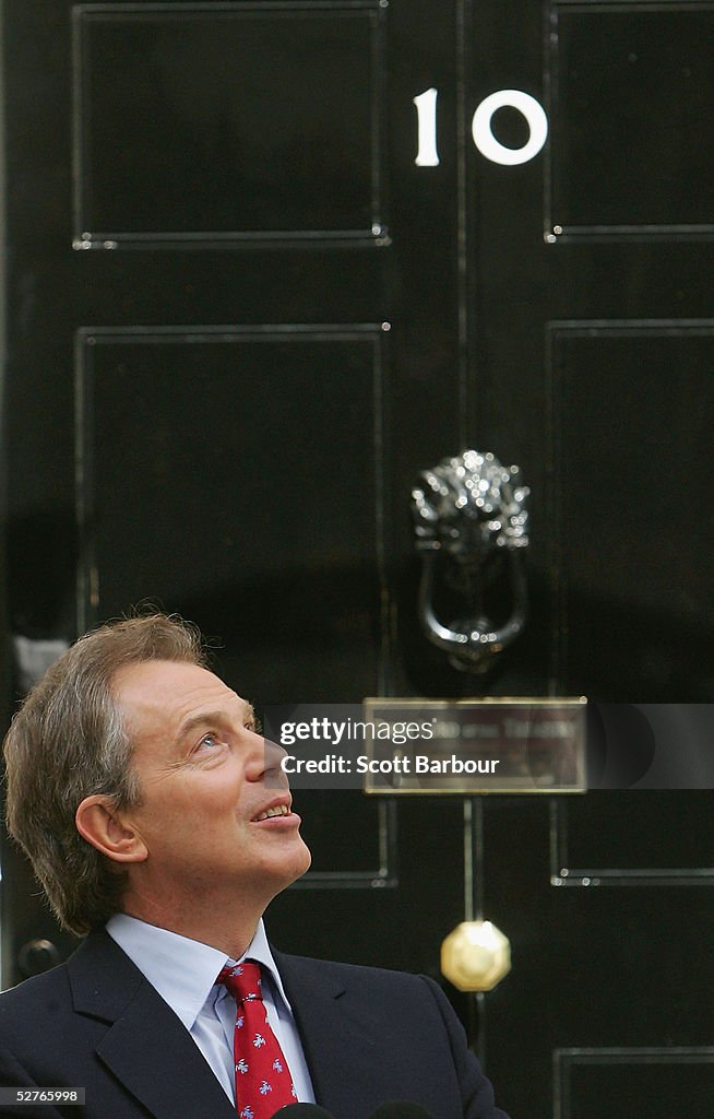 Britain's Prime Minister Tony Blair looks skyward after returning to