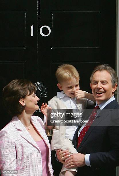 Britain's Prime Minister Tony Blair poses for photographers along with wife Cherie and son Leo on the doorstep after returning to 10 Downing Street...