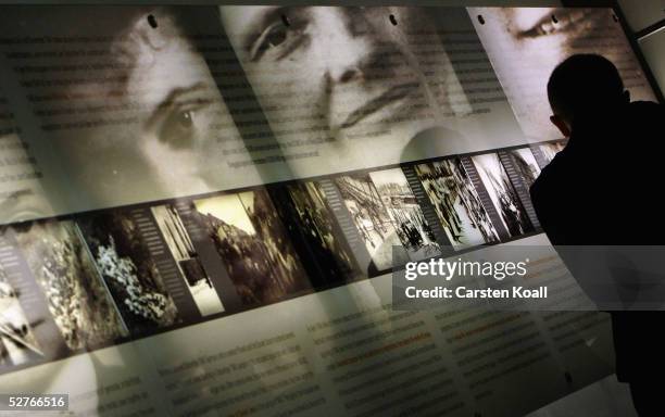 Journalists visiting the information center of the Holocaust Memorial to the Murdered Jews of Europe view photographs of Jews murdered by the Nazis...