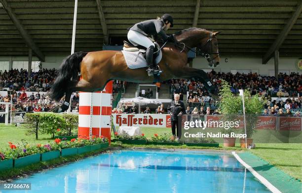 Inga Rauert of Germany jumps on her horse Lerano over the waterpool to victory in the Sprehe Feinkost Preis of the German Jumping and Dressage Grand...