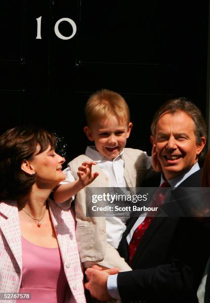 Britain's Prime Minister Tony Blair poses for photographers with son Leo and wife Cherie on the doorstep after returning to 10 Downing Street on May...