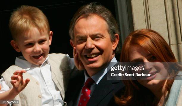 Britain's Prime Minister Tony Blair poses for photographers with son Leo and daughter Kathryn on the doorstep after returning to 10 Downing Street on...
