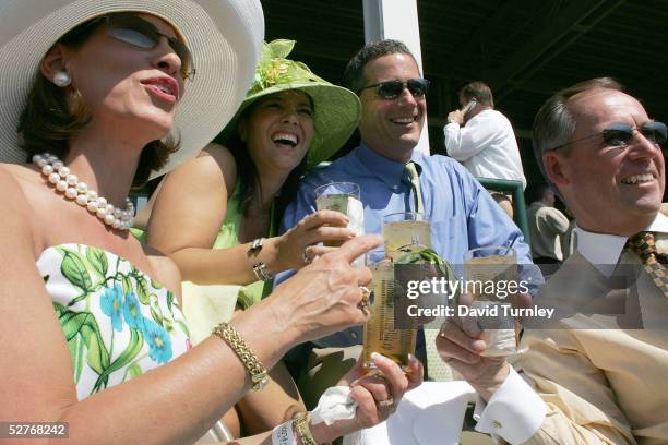 Fans Deanne Cheadle, Tracy Payne, Kevin Payne and Jerry Cheadle enjoy mint julips during the morning races in preparation for the 131st Kentucky...