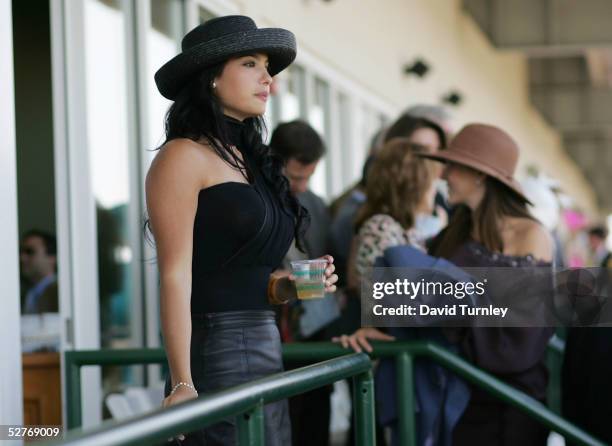 Woman watches the Oaks Day Races leading up to tomorrow's 131st Kentucky Derby May 6, 2005 at Churchill Downs in Louisville, Kentucky.
