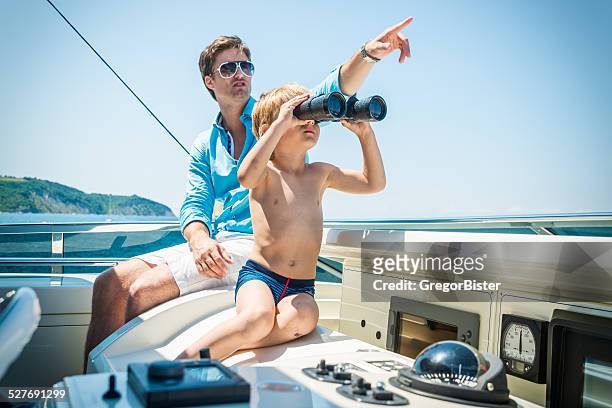 father and son on yacht - cruise crew stock pictures, royalty-free photos & images
