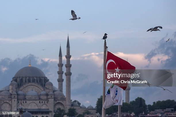 Seagulls fly over a Turkish flag on May 3, 2016 in Istanbul Turkey. The European Commission is expected to recommend granting Turks with visa free...