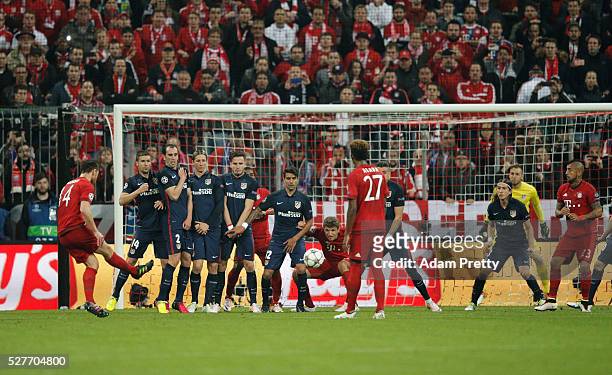 Xabi Alonso of Bayern Munich scores their first goal from a free kick during UEFA Champions League semi final second leg match between FC Bayern...
