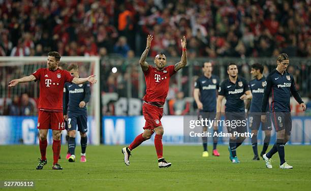 Arturo Vidal of Bayern Munich celebrates as Xabi Alonso of Bayern Munich scores their first goal from a free kick during UEFA Champions League semi...