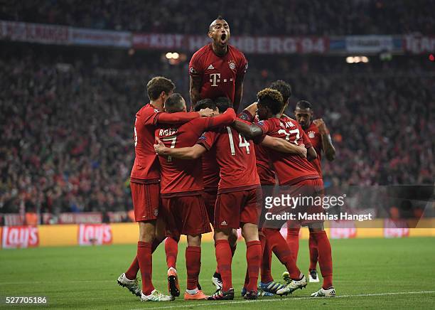 Xabi Alonso of Bayern Munich celebrates with team mates as he scores their first goal from a free kick during UEFA Champions League semi final second...