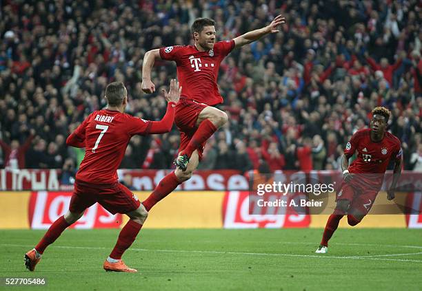 Xabi Alonso of Bayern Muenchen celebrates his first goal with teammates Franck Ribery and David Alaba during the Champions League semi final second...