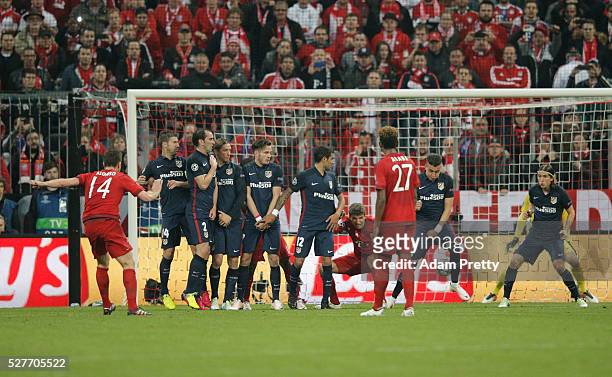 Xabi Alonso of Bayern Munich scores their first goal from a free kick during UEFA Champions League semi final second leg match between FC Bayern...