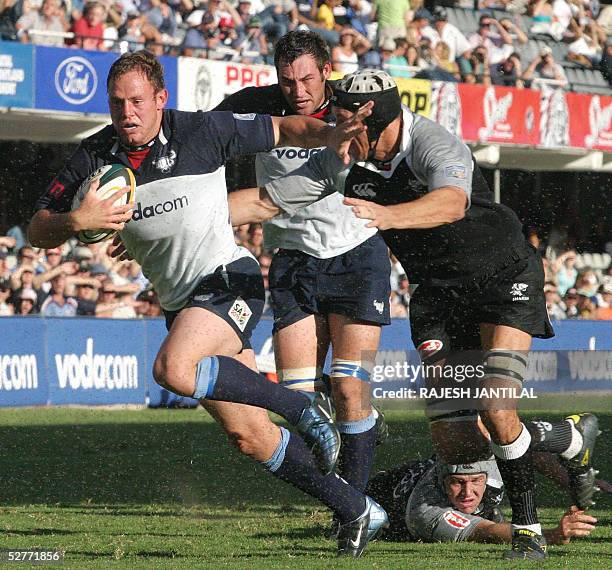 Bulls full back Johan Roets runs away with the oval from a Sharks player, 07 May 2005 at Durban's ABSA Rugby stadium during their Super 12 Rugby...