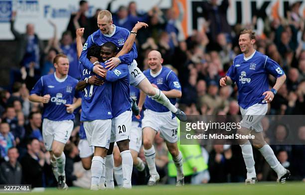 Tim Cahill of Everton is congratulated by Joseph Yobo and Tony Hibbert after scoring the second goal during the Barclays Premiership match between...