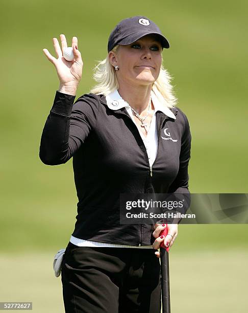 Danielle Amiee, winner of the Golf Channel's Big Break III, waves to the gallery on the ninth green after finishing the second round of the Michelob...