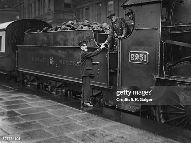 Great Western Railway guard James Tidball , who is retiring after 51 year's service, is congratulated by the driver of his last train, 9th June 1928.