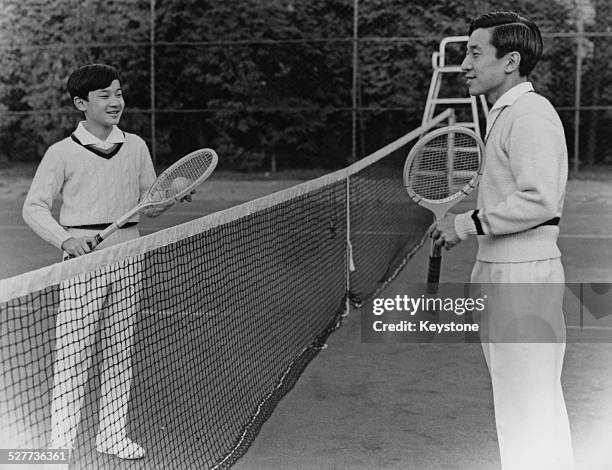 Prince Hiro, the eldest son of Emperor Akihito and Empress Michiko of Japan, playing tennis with his father in Tokyo, around the time of his 13th...