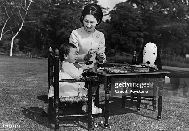 Empress Michiko of Japan with her daughter Sayako, Princess Nori, in the grounds of the palace in Tokyo, Japan, around the time of her 36th birthday,...