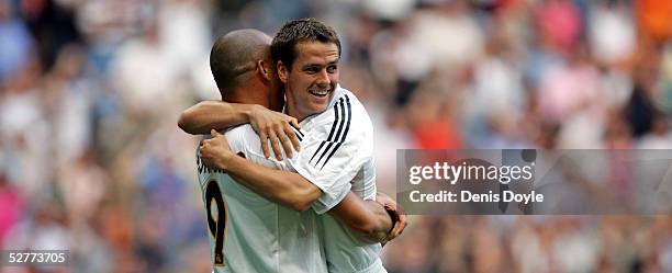 Michael Owen of Real Madrid celebrates with Ronaldo after scoring a goal during a La Liga match between Real Madrid and Racing de Santander at the...