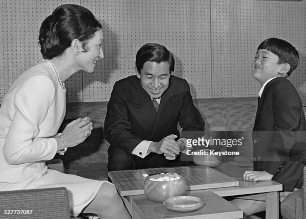 Prince Aya, the second son of Emperor Akihito and Empress Michiko of Japan, playing Go with his parents around the time of his 8th birthday, Japan,...