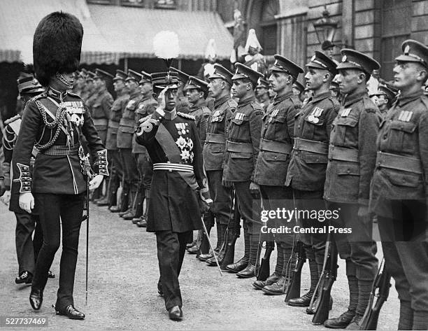 Hirohito, the Crown Prince of Japan inspects a Guard of Honour of World War I heroes at the Guildhall in London during his six-month European tour,...