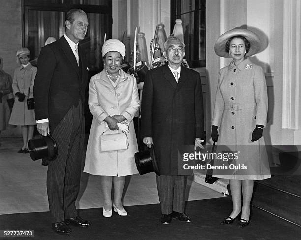 Emperor Hirohito and Empress Nagako of Japan pose with Queen Elizabeth II and Prince Philip at Buckingham Palace, at the start of a three-day visit...