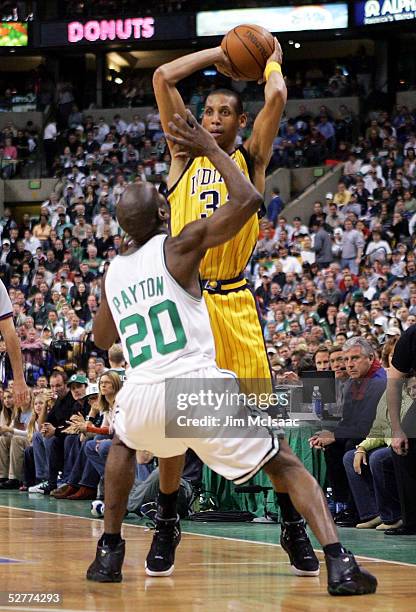 Reggie Miller of the Indiana Pacers is defended by Gary Payton of the Boston Celtics as he looks to pass to a teammate in Game seven of the Eastern...