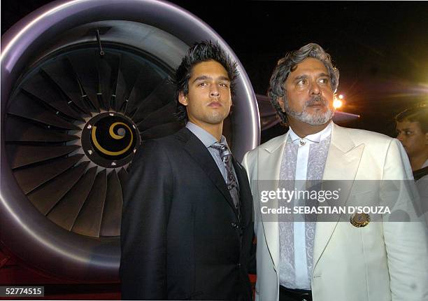 Chairman of United Beveries Group, Dr.Vijay Mallya along with his son Sidharth pose for photographers beside his aircraft at the announcement of the...