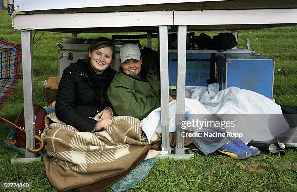 Spectators attempt to shelter from the rain during the German Jumping and Dressage Grand Prix at the Derby Park Hamburg Klein Flottbek on May 8, 2005...