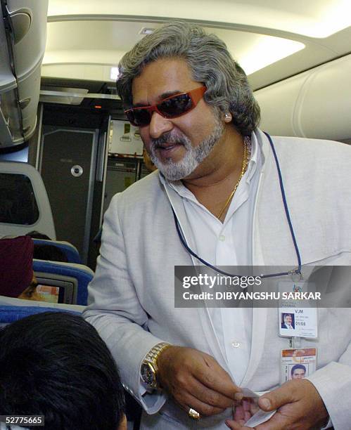 Chairman of United Breweries Holding Limited Vijay Mallya stands in the cabin, during a special flight carrying invitees and journalists, in the sky...