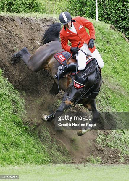 Holger Wulschner of Germany falls from his horse Dublin at the Tschibo wall during the 76. German Jumping-Derby 2005 of the German Jumping and...