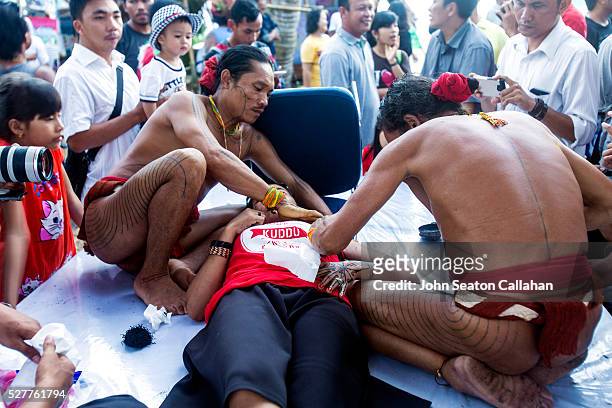 demonstration of mentawai tattooing - mentawai islands stock pictures, royalty-free photos & images