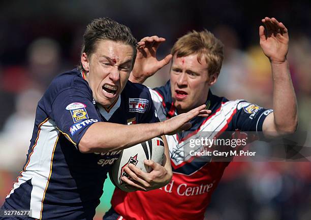 Luke Dorn of London Broncos tries to get away from David Hodgson fo Salford City Reds during the Powergen Challenge Cup 5th round match between...