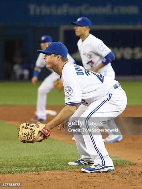 Matt Dominguez of the Toronto Blue Jays gets ready to field his position at first base on a drawn-in infield in the ninth inning during MLB game...